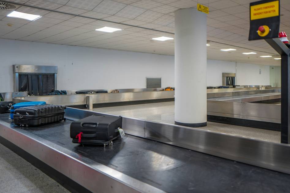 Suitcase with delay compensation receipt on wooden table